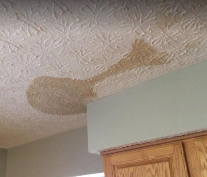 brown discoloration on white ceiling
